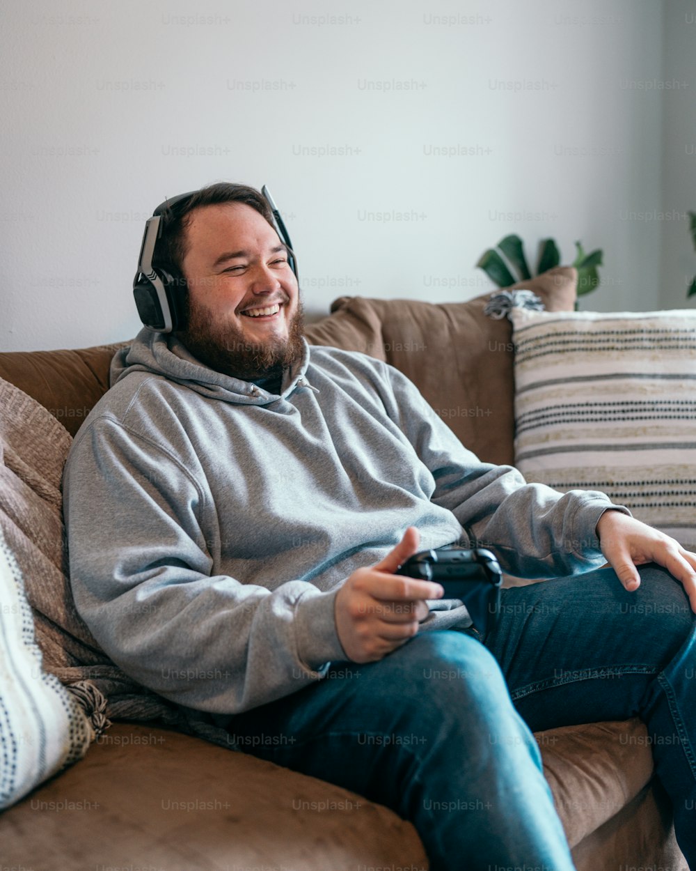 a man sitting on a couch with headphones on