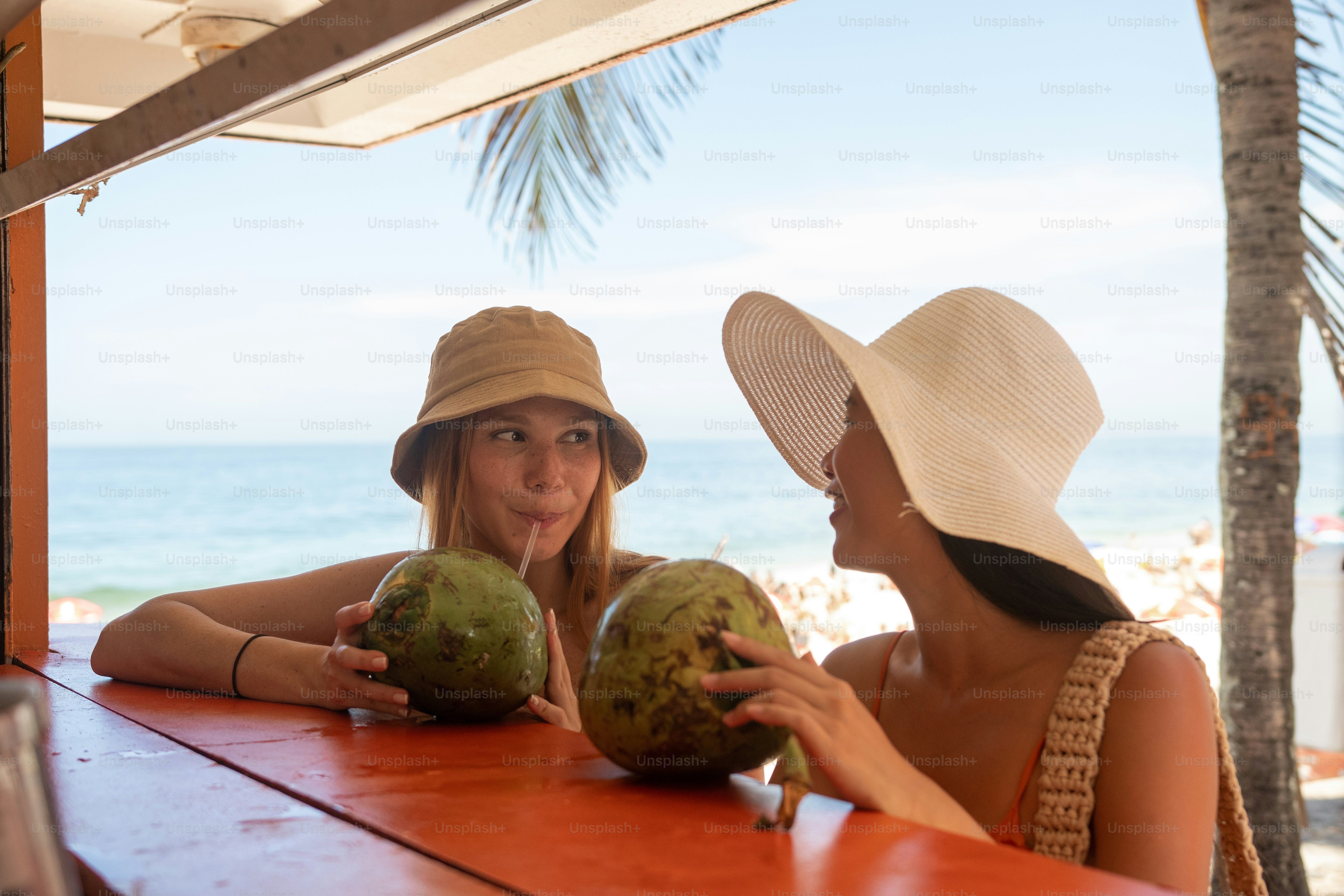 a couple of women sitting at a table next to each other