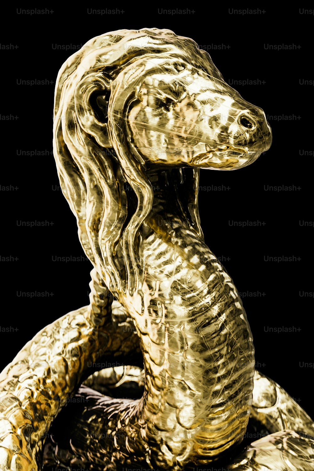 a golden statue of a snake on a black background