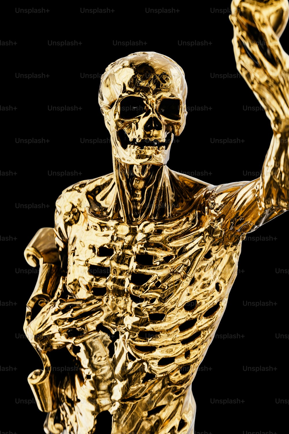 a gold statue of a skeleton holding a tennis racquet