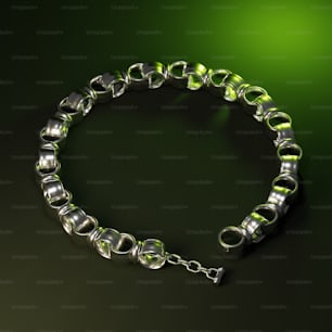 a green and silver bracelet on a black background