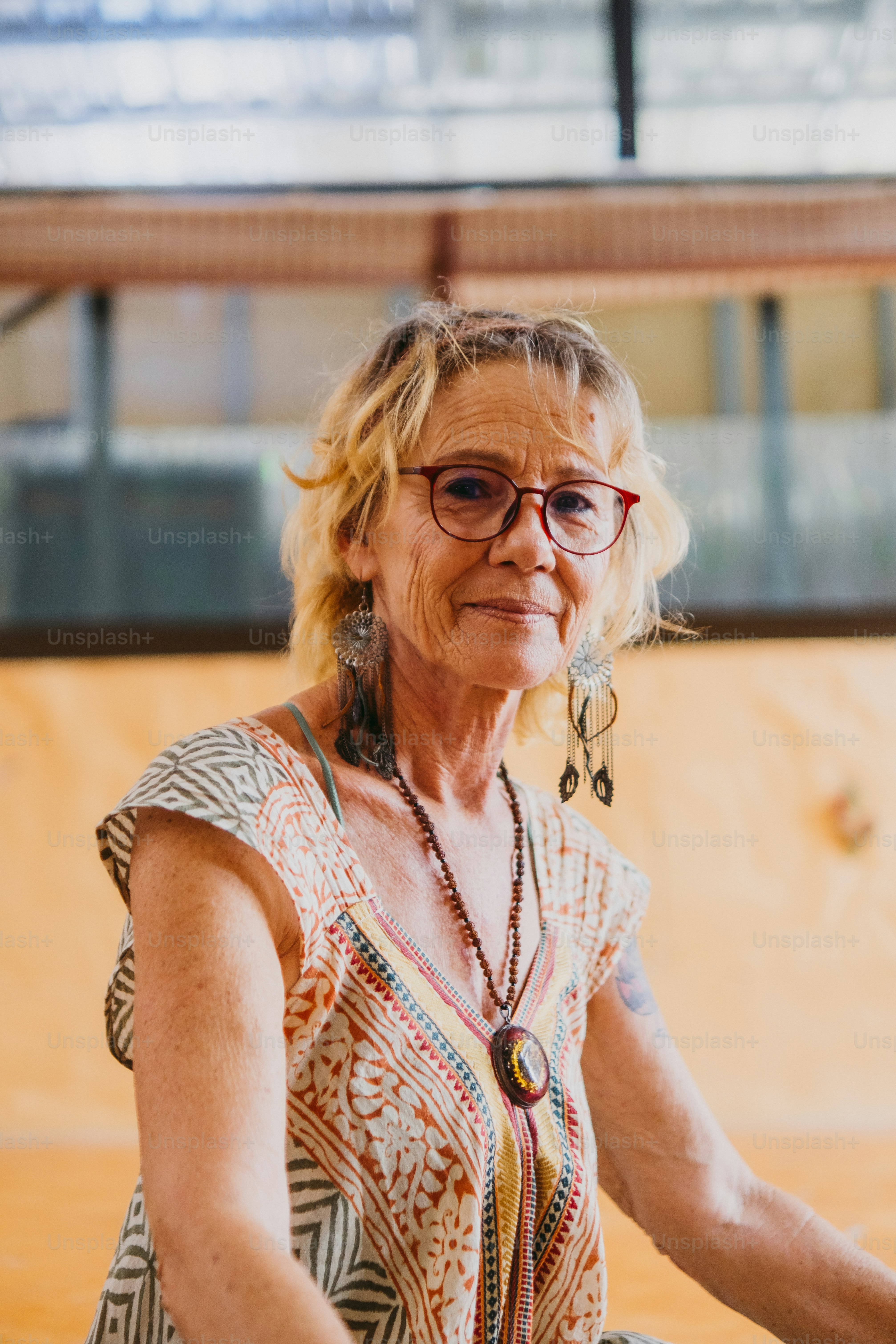 a woman with glasses sitting on a skateboard ramp