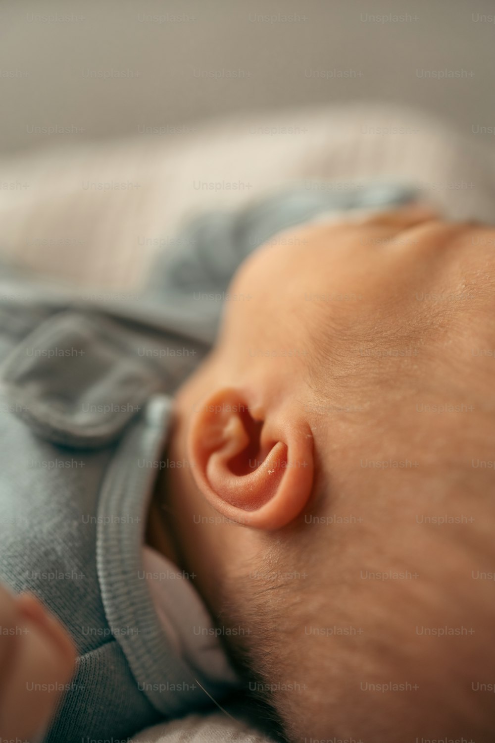 a close up of a baby laying on a bed