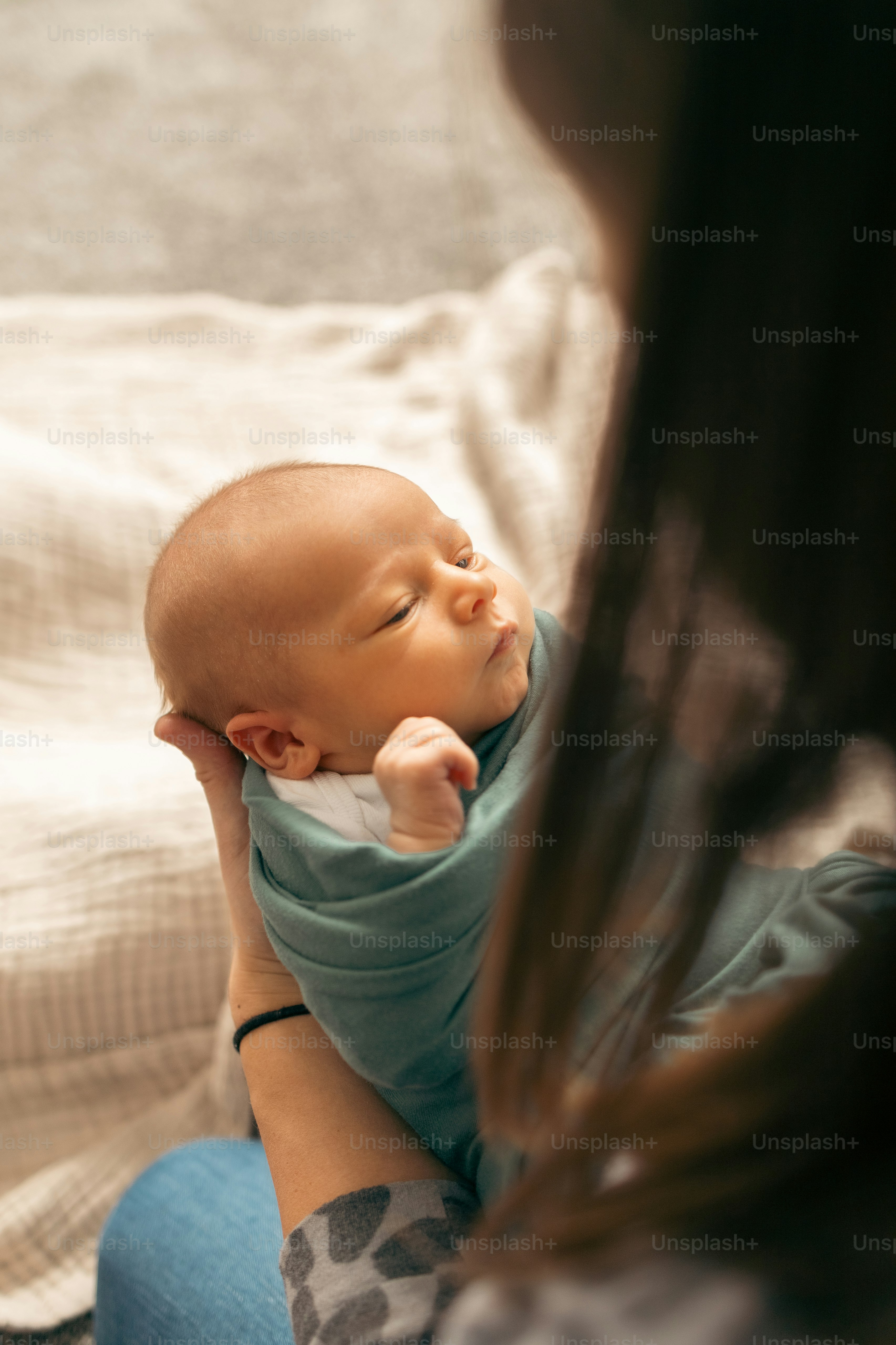 赤ん坊を腕に抱く女性