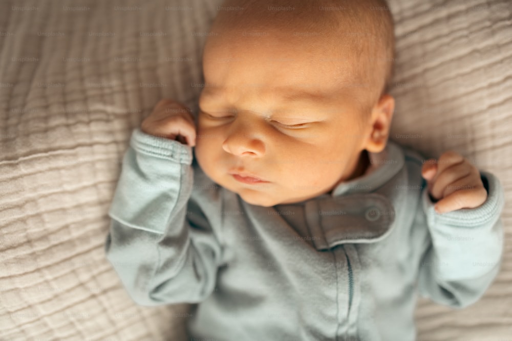 a baby is laying down on a bed