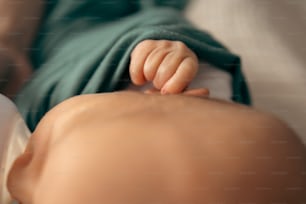 a close up of a baby laying on a bed