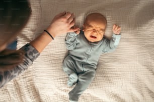 a baby crying while being held by a woman