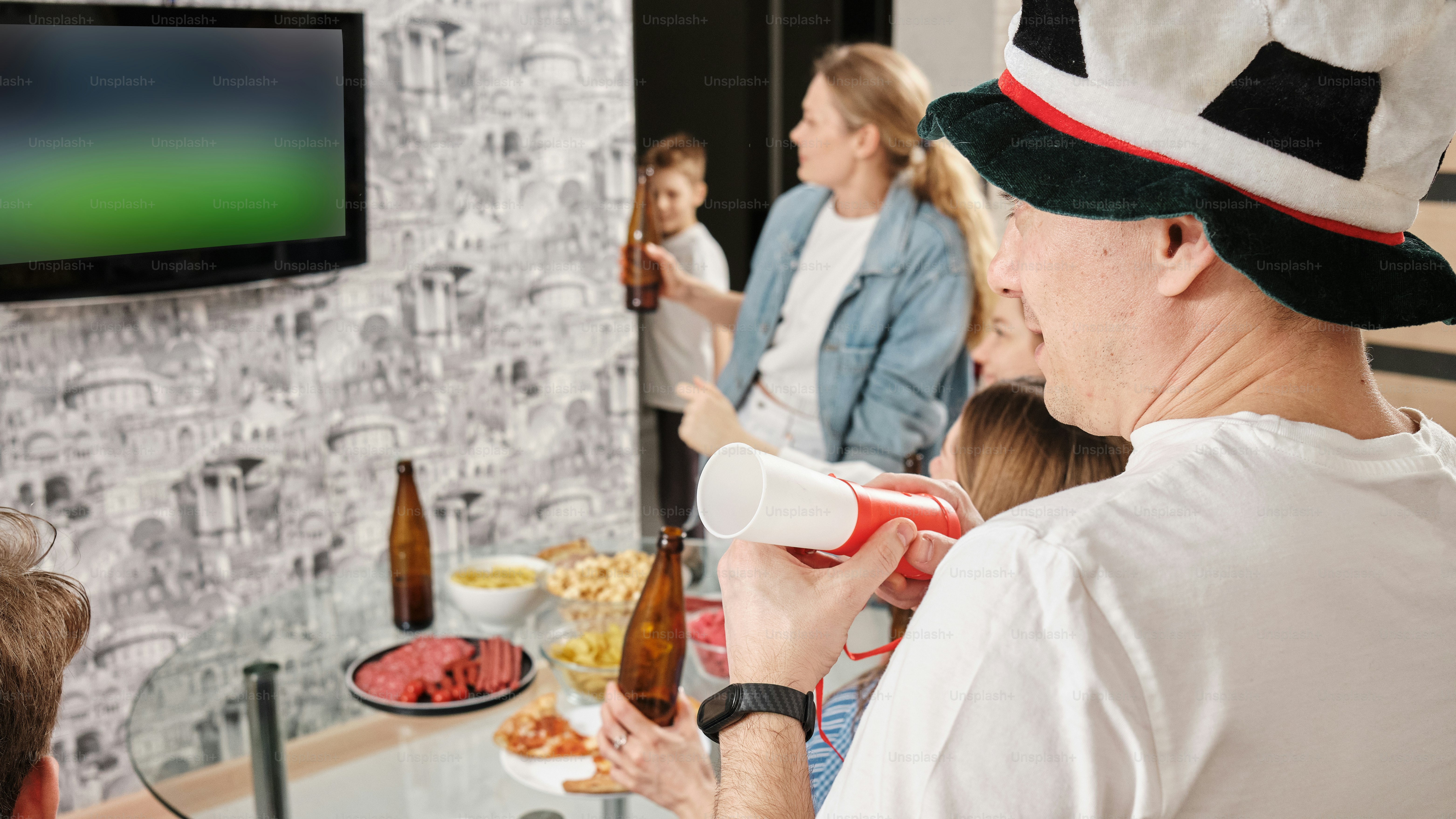 Group of friends watching the game at the apartment