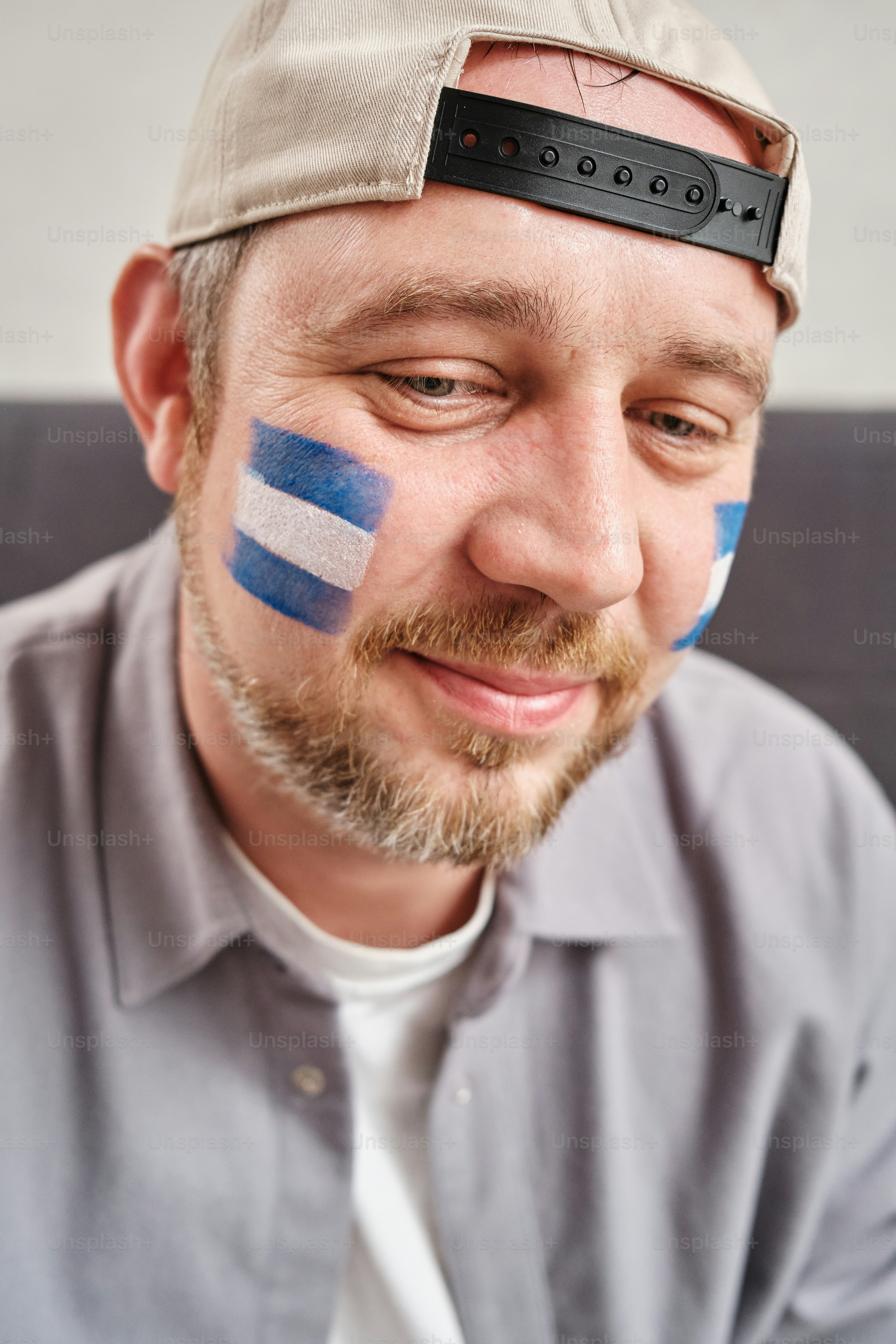 portrait of sports fan with fan’s country flag makeup