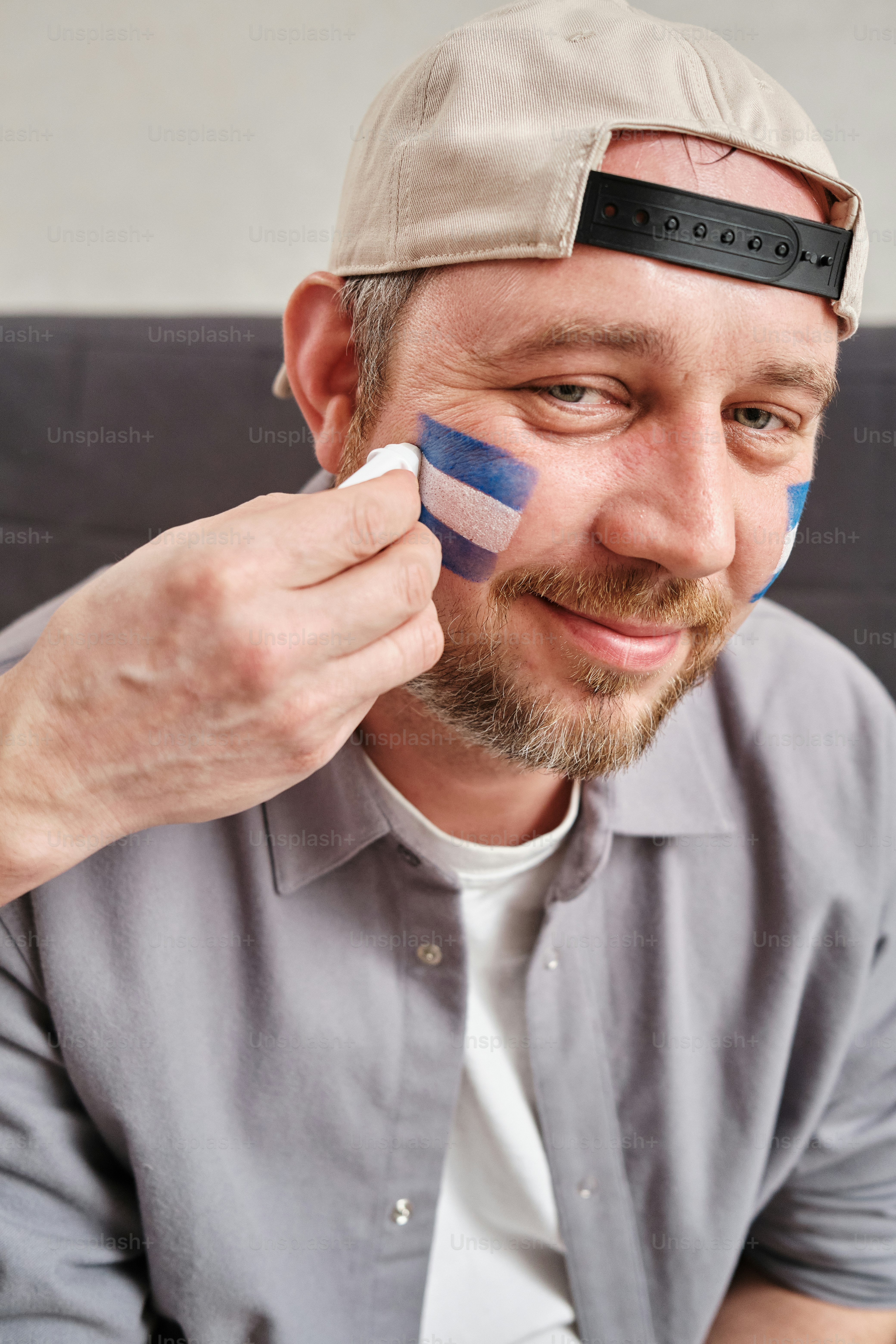 portrait of sports fan with fan’s country flag makeup