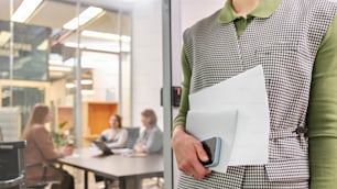 a person holding a folder in a meeting room