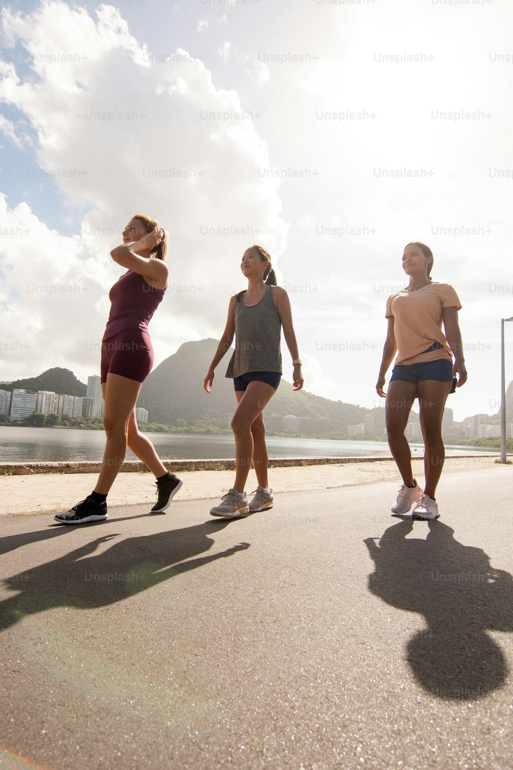 a group of young women riding skateboards down a street