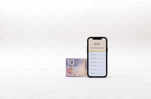a bank note sitting next to a phone