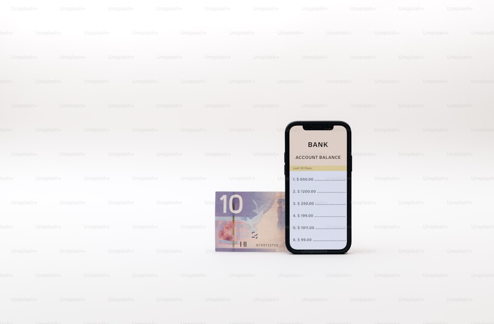 a bank note sitting next to a phone