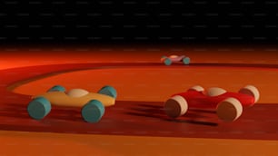 Un grupo de coches de juguete sentados encima de un suelo rojo