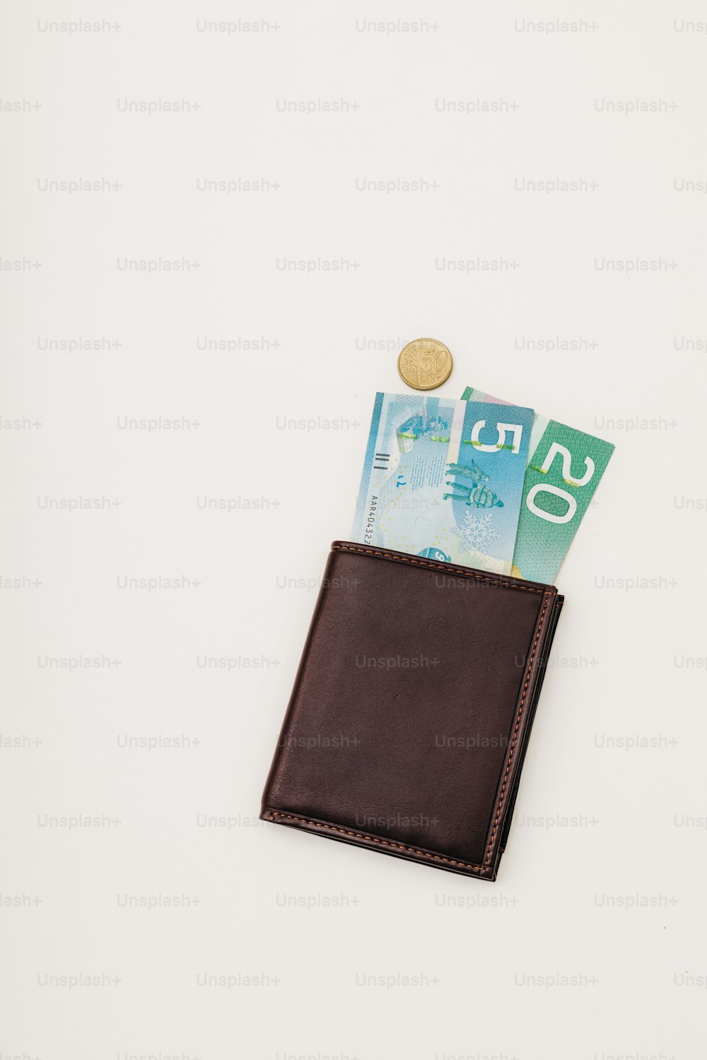 a leather wallet with money sticking out of it