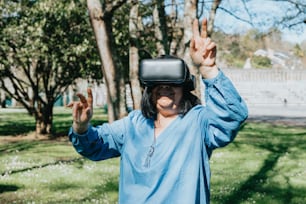 a woman wearing a virtual reality headset in a park