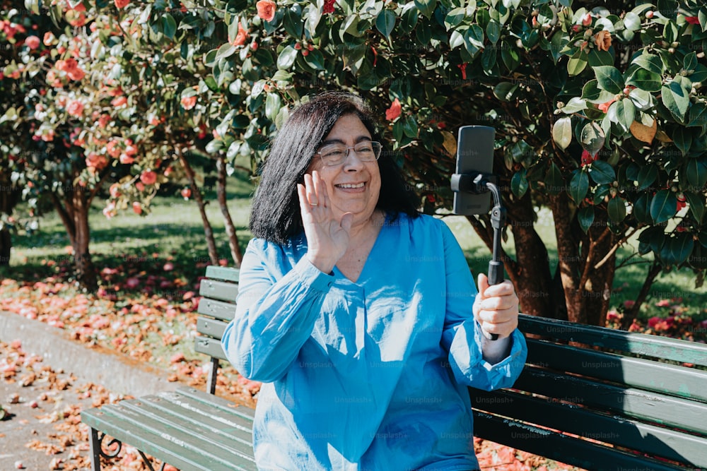 a woman sitting on a bench holding a cell phone