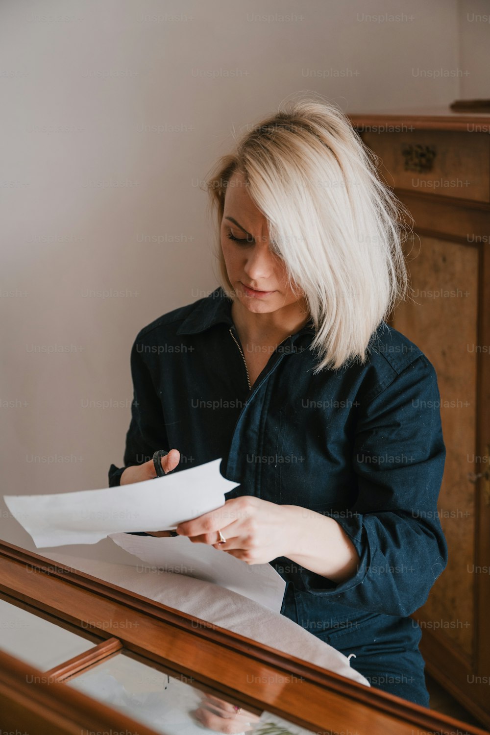 a woman sitting at a table with a piece of paper