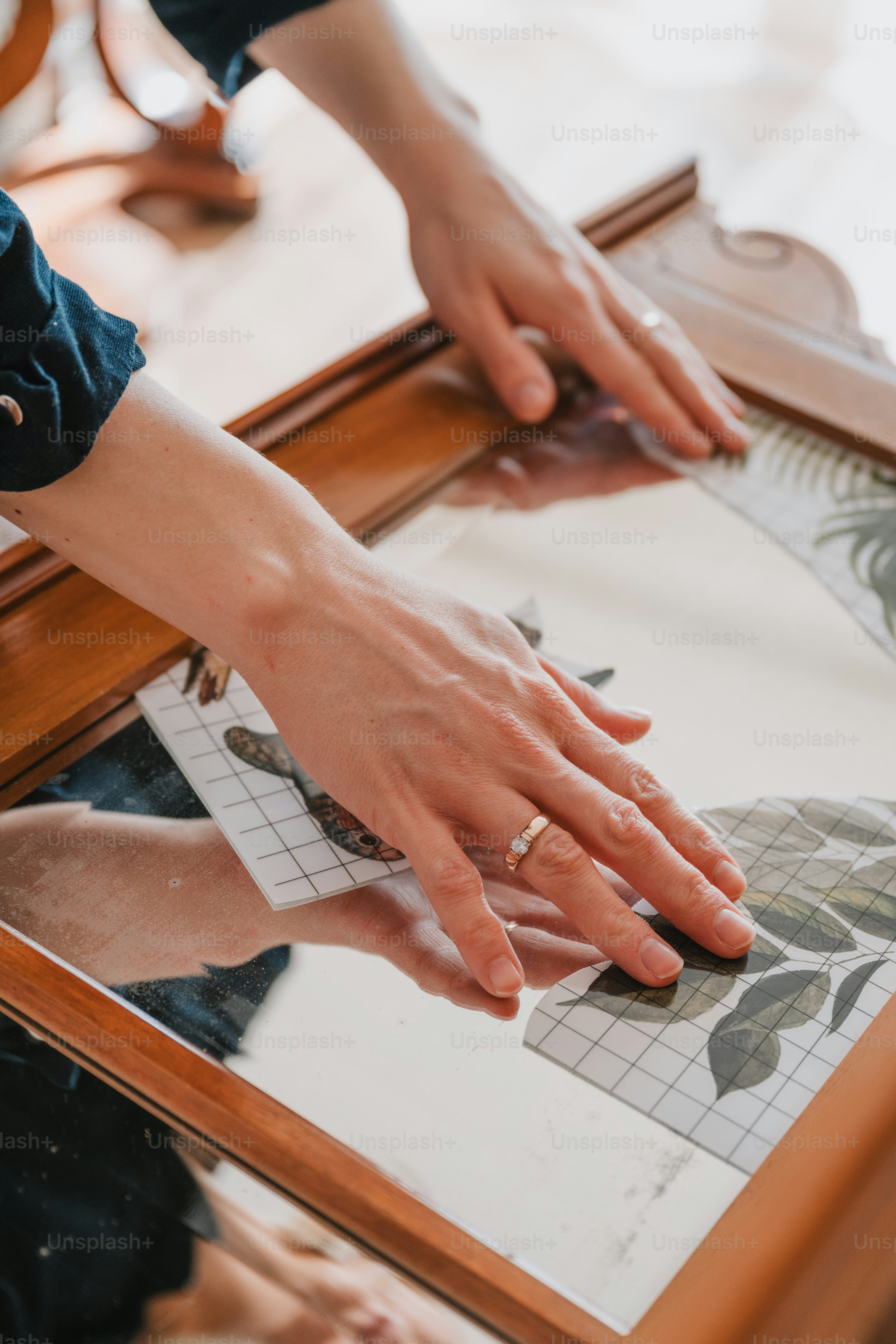 a person's hands on top of a mirror