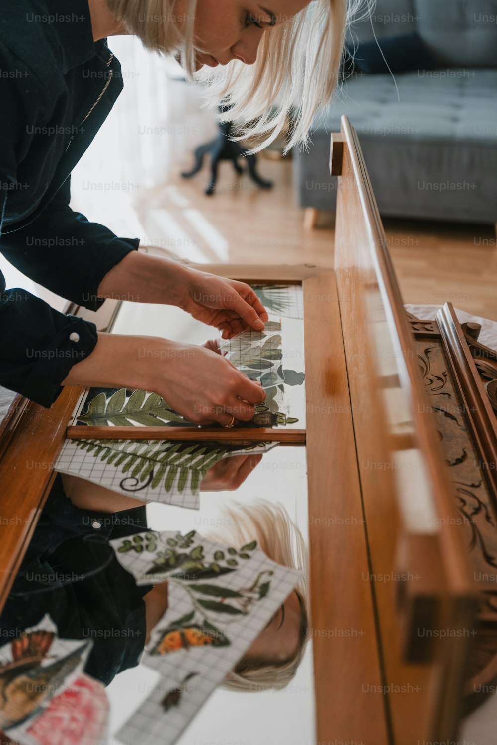 a woman is working on a piece of artwork