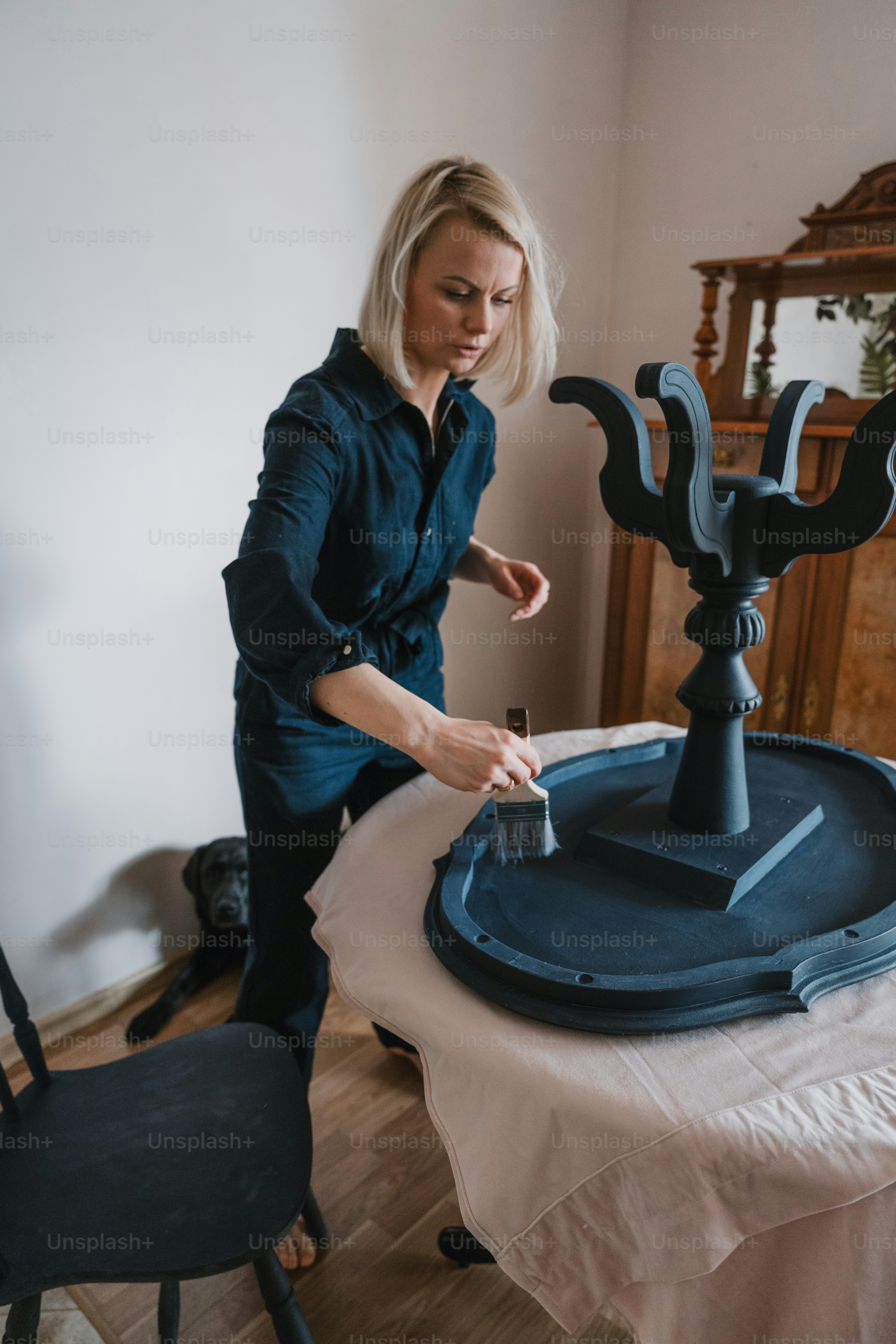 a woman standing over a table with a tray on it