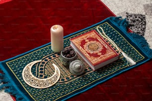 a candle and a book on a rug