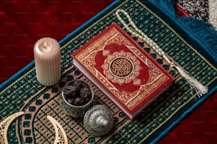 a candle and a book on a rug