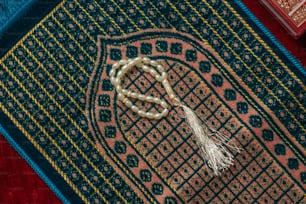 a rug with a tassel on top of it