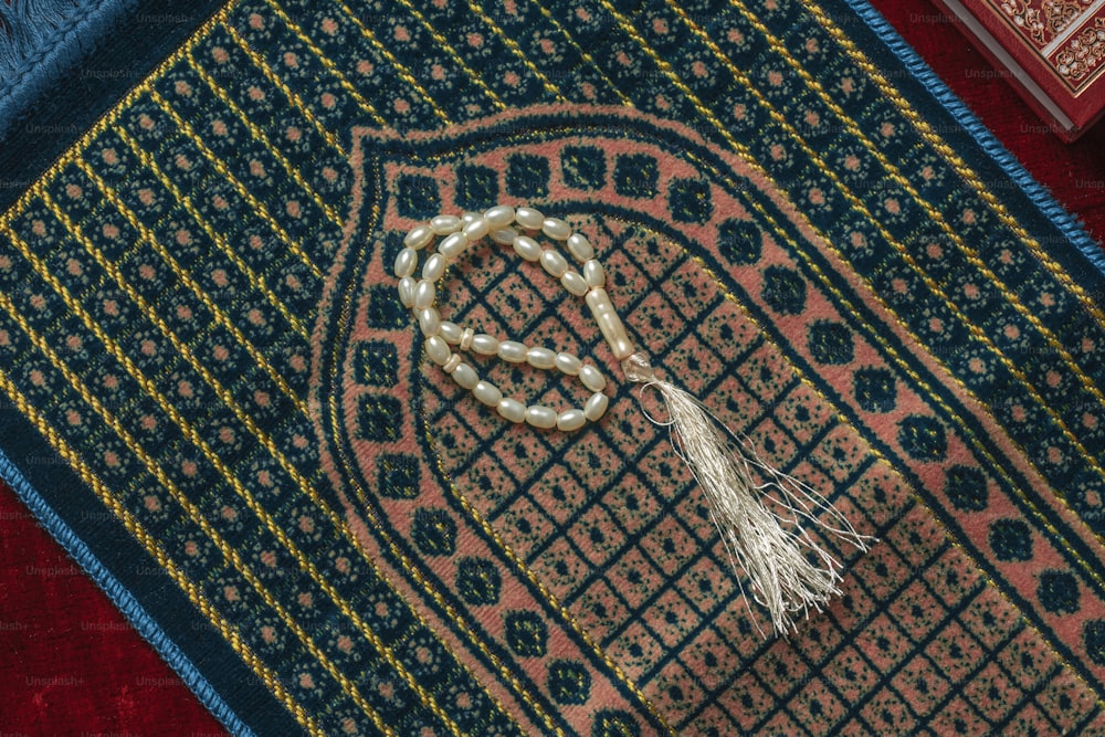 a rug with a tassel on top of it