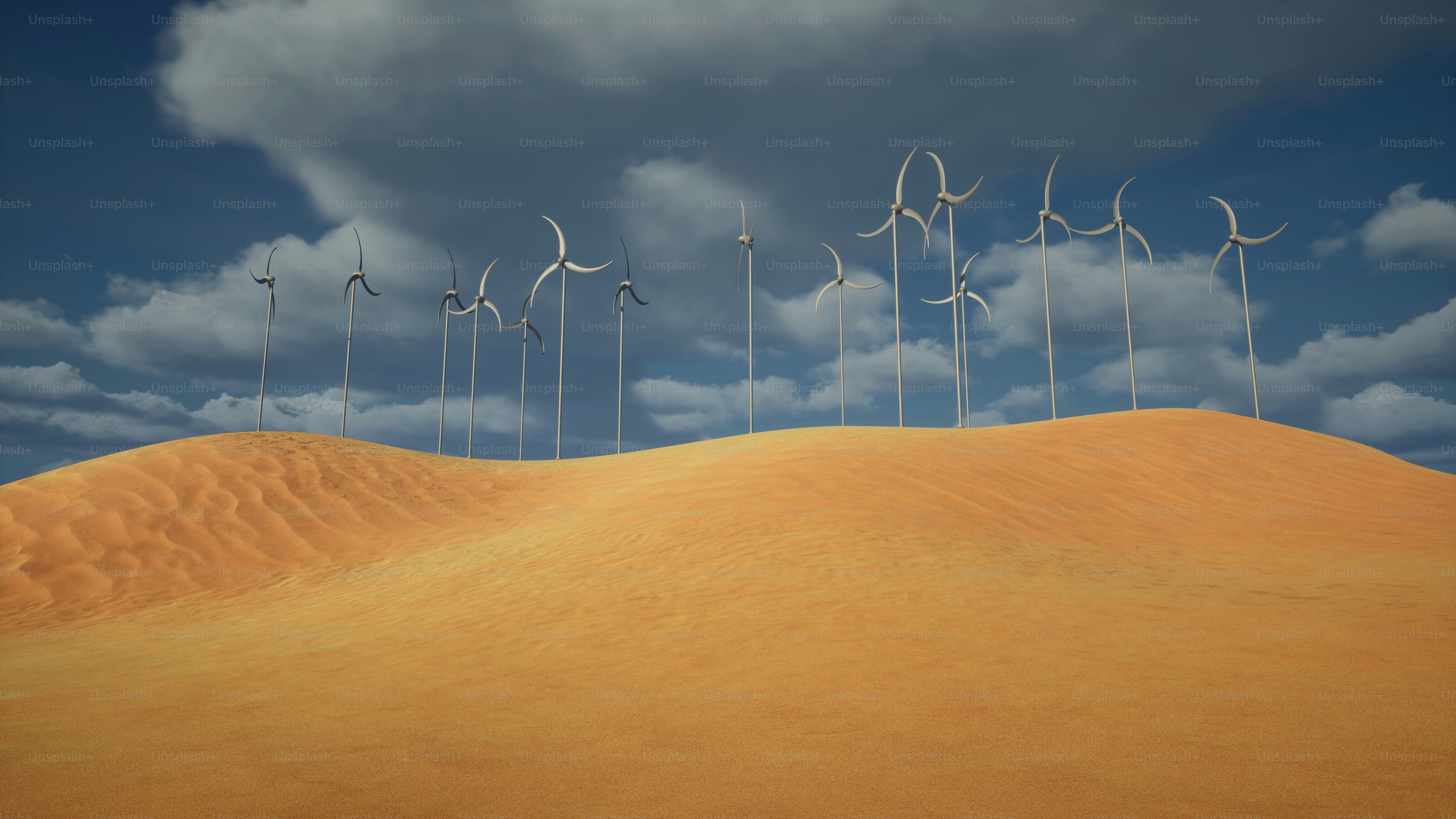 a row of wind mills on top of a sandy hill