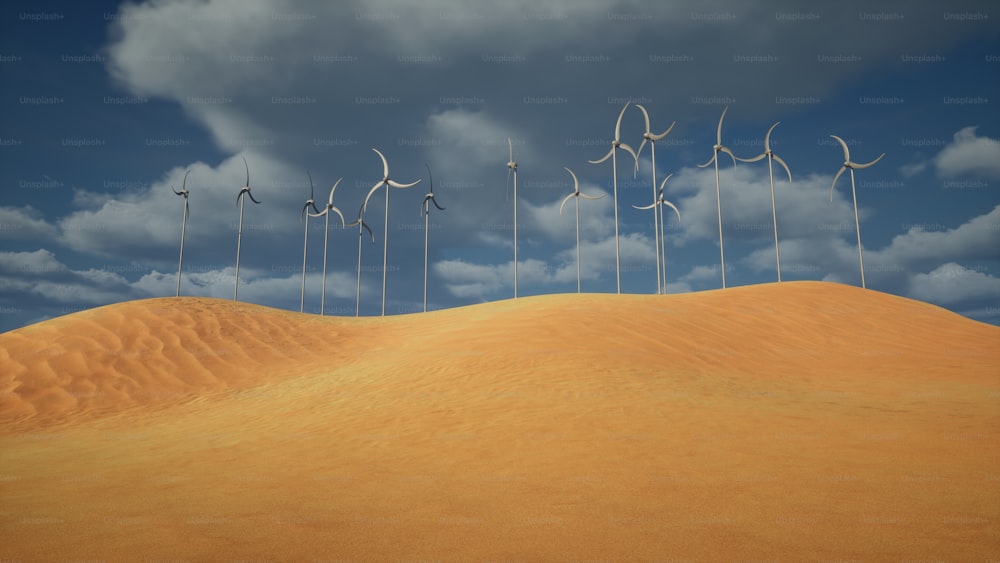 a row of wind mills on top of a sandy hill