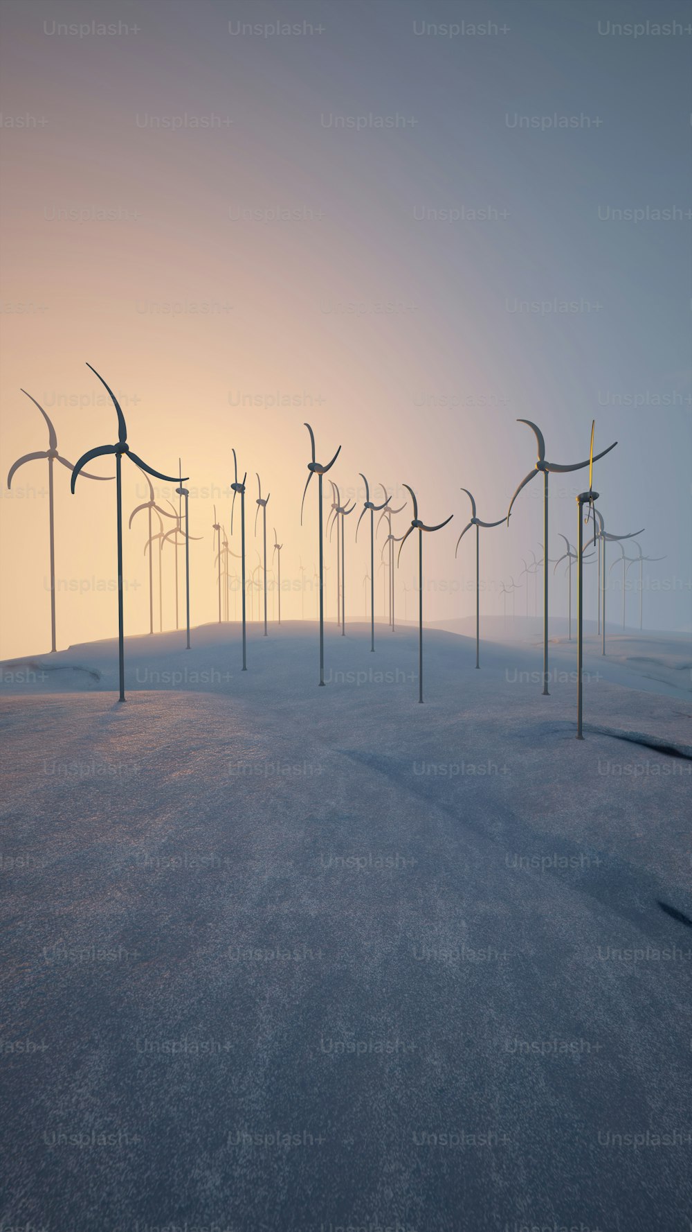 a row of wind mills in a foggy field