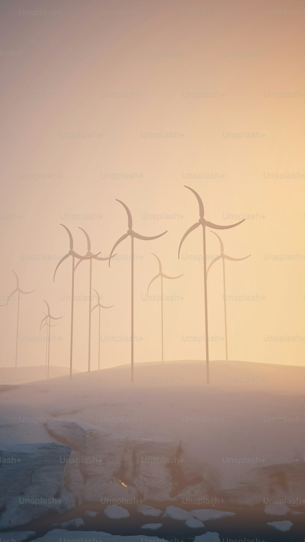 a group of wind turbines on a snowy hill