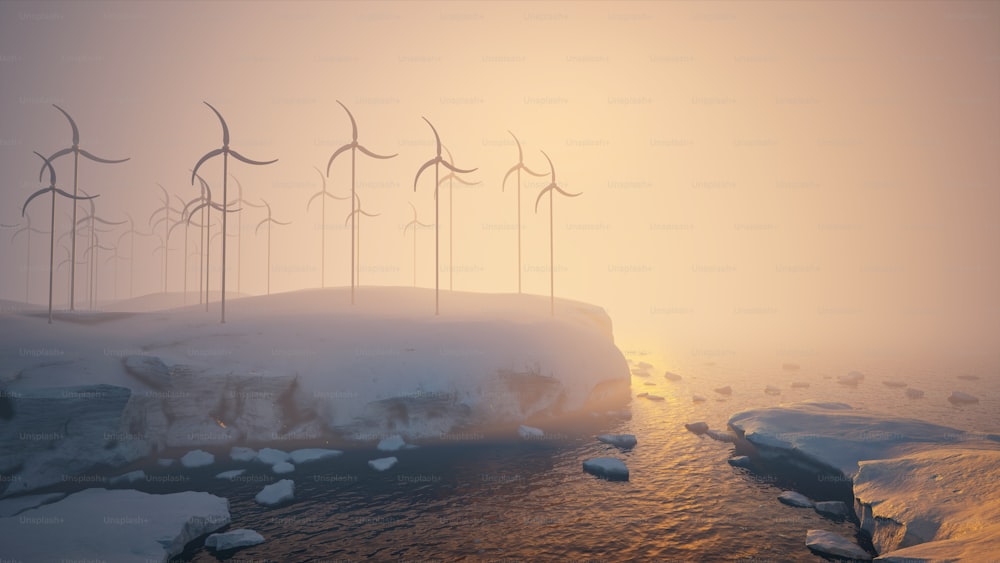 a group of windmills on a snowy hill next to a body of water