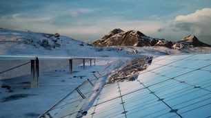 a snow covered mountain with a metal roof