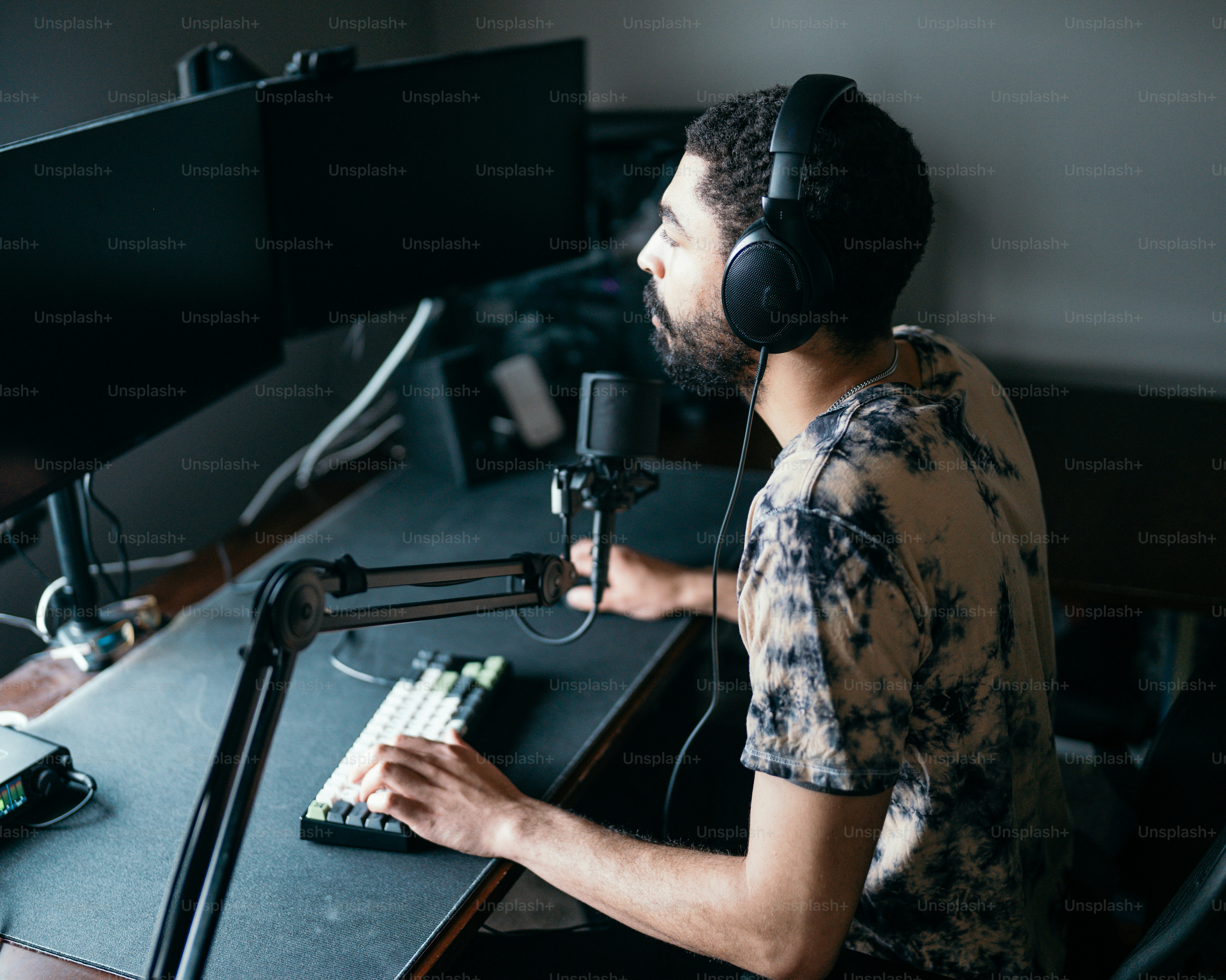 a man wearing headphones sitting in front of a microphone