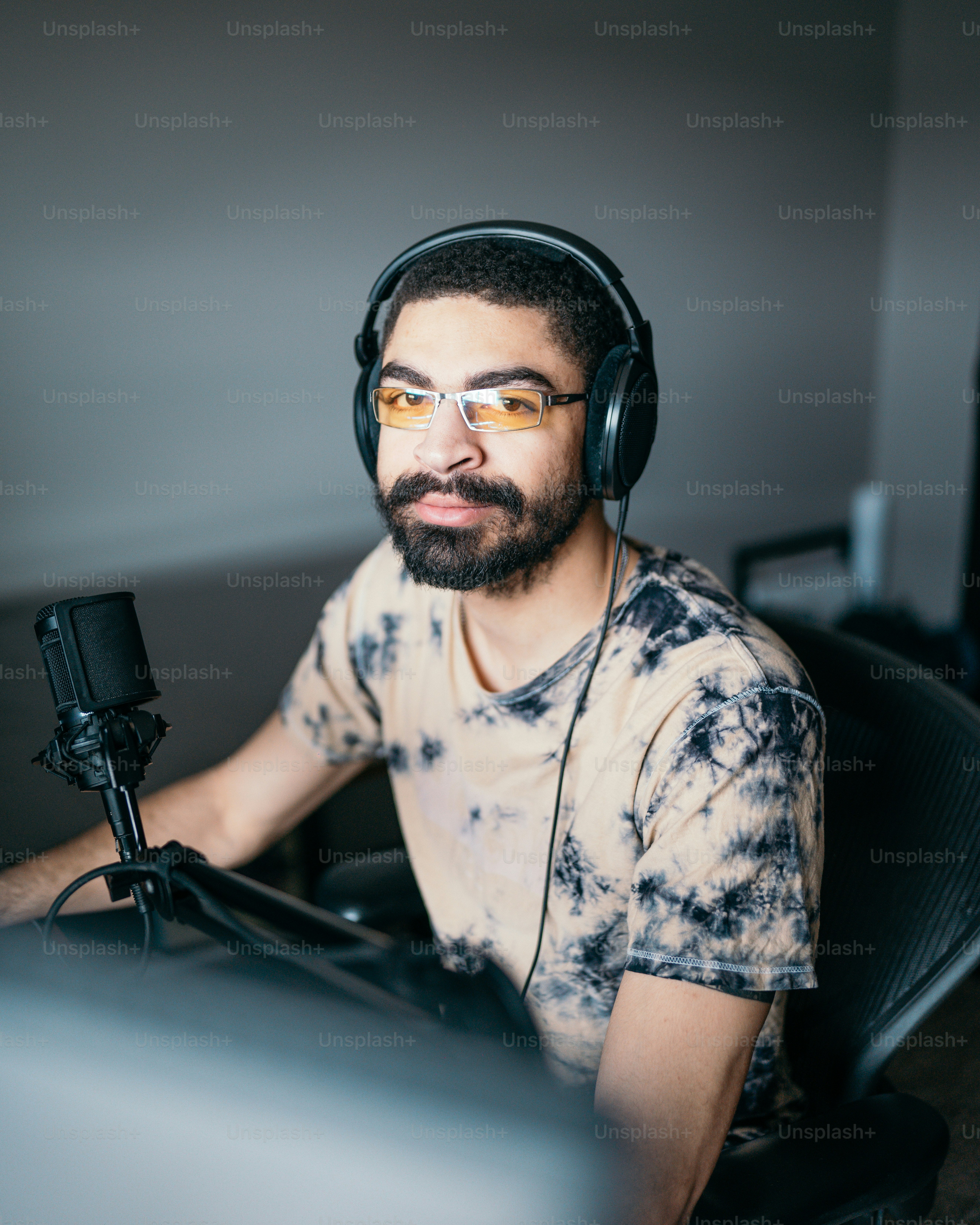 a man wearing headphones sitting in front of a computer