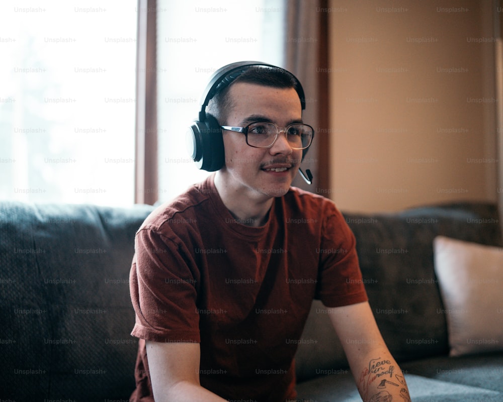 a man wearing headphones sitting on a couch