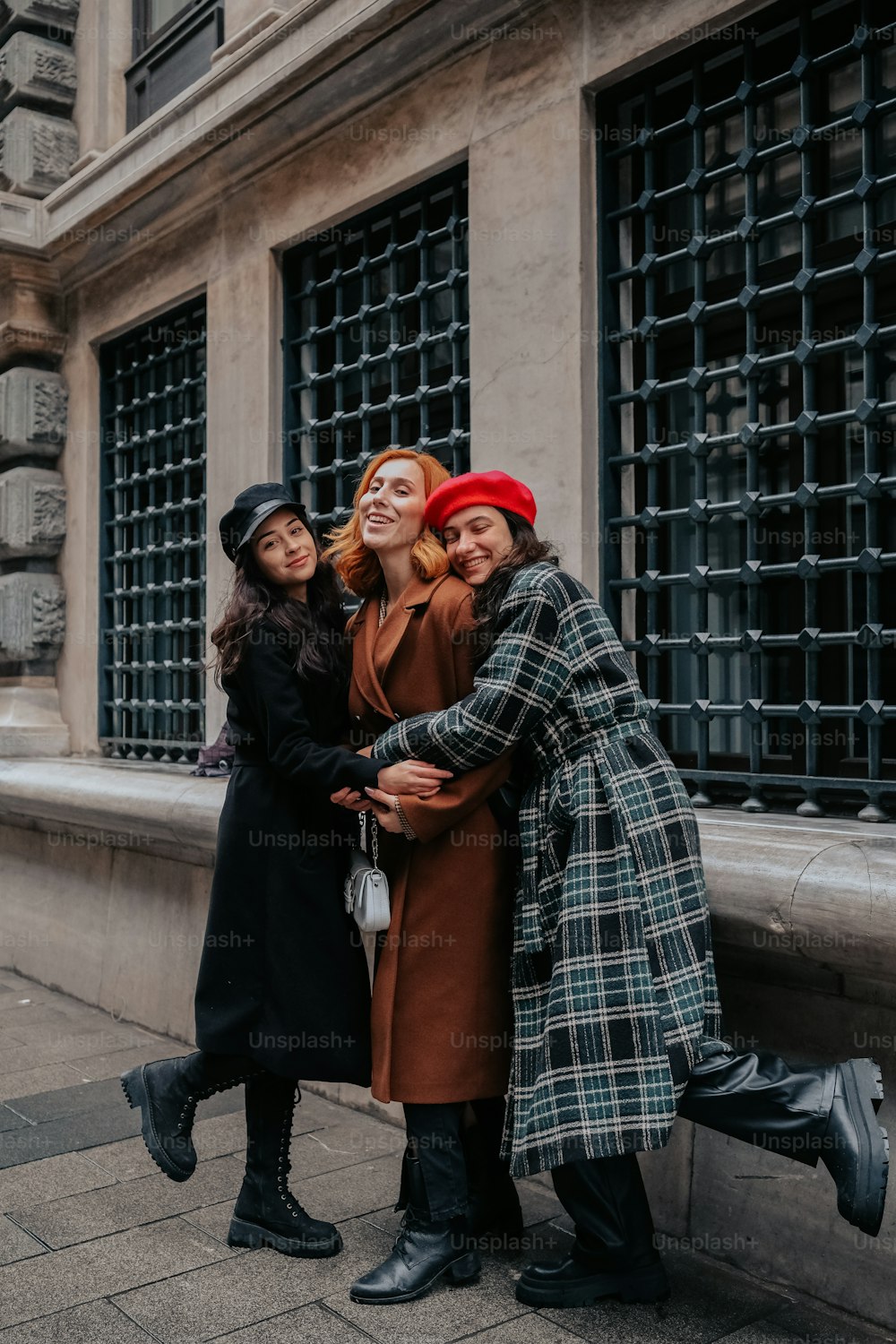 a group of three women standing next to each other