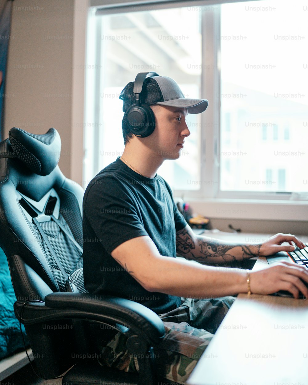 a man sitting in front of a computer wearing headphones