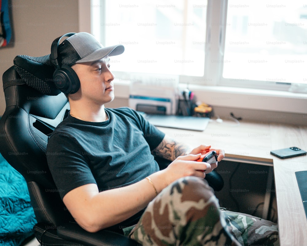 a man sitting in a chair with headphones on