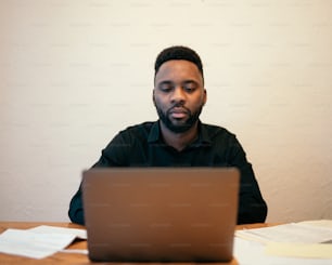 Un homme assis devant un ordinateur portable