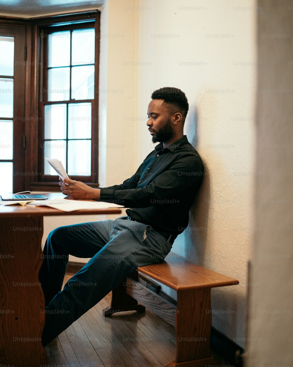 a man sitting at a table using a tablet