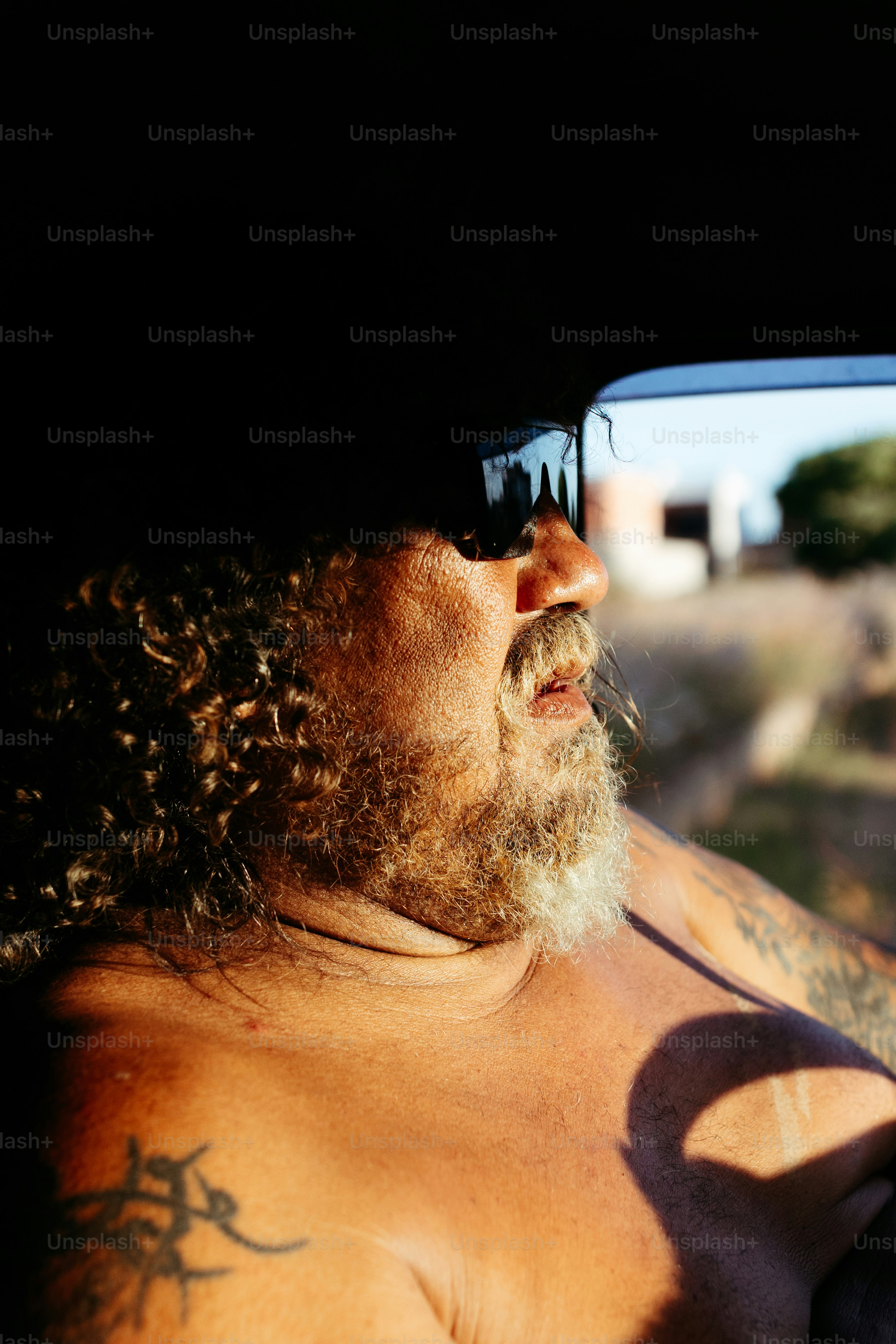 a man with long hair and a beard wearing sunglasses