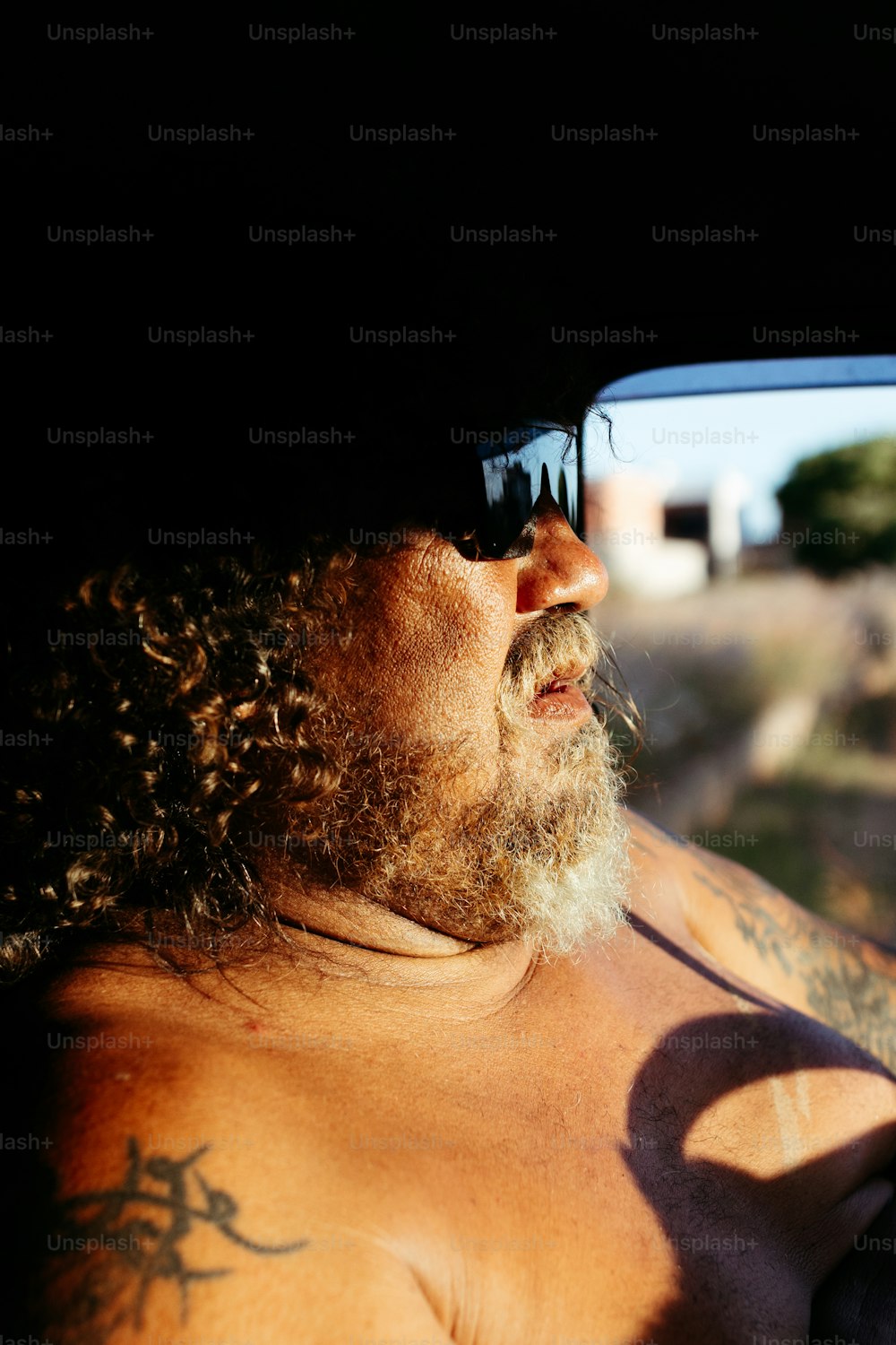 a man with long hair and a beard wearing sunglasses