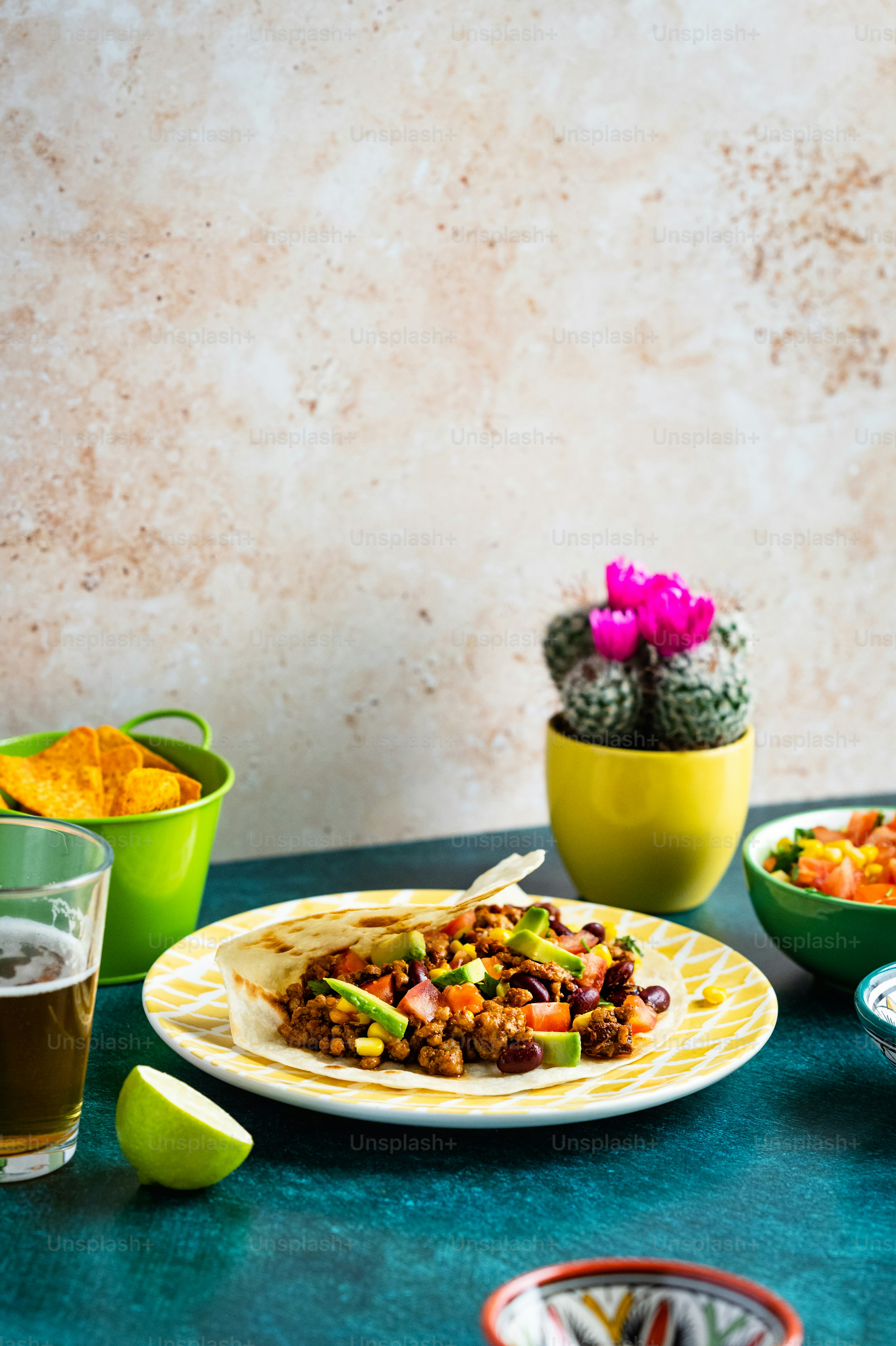 a table topped with plates of food and drinks