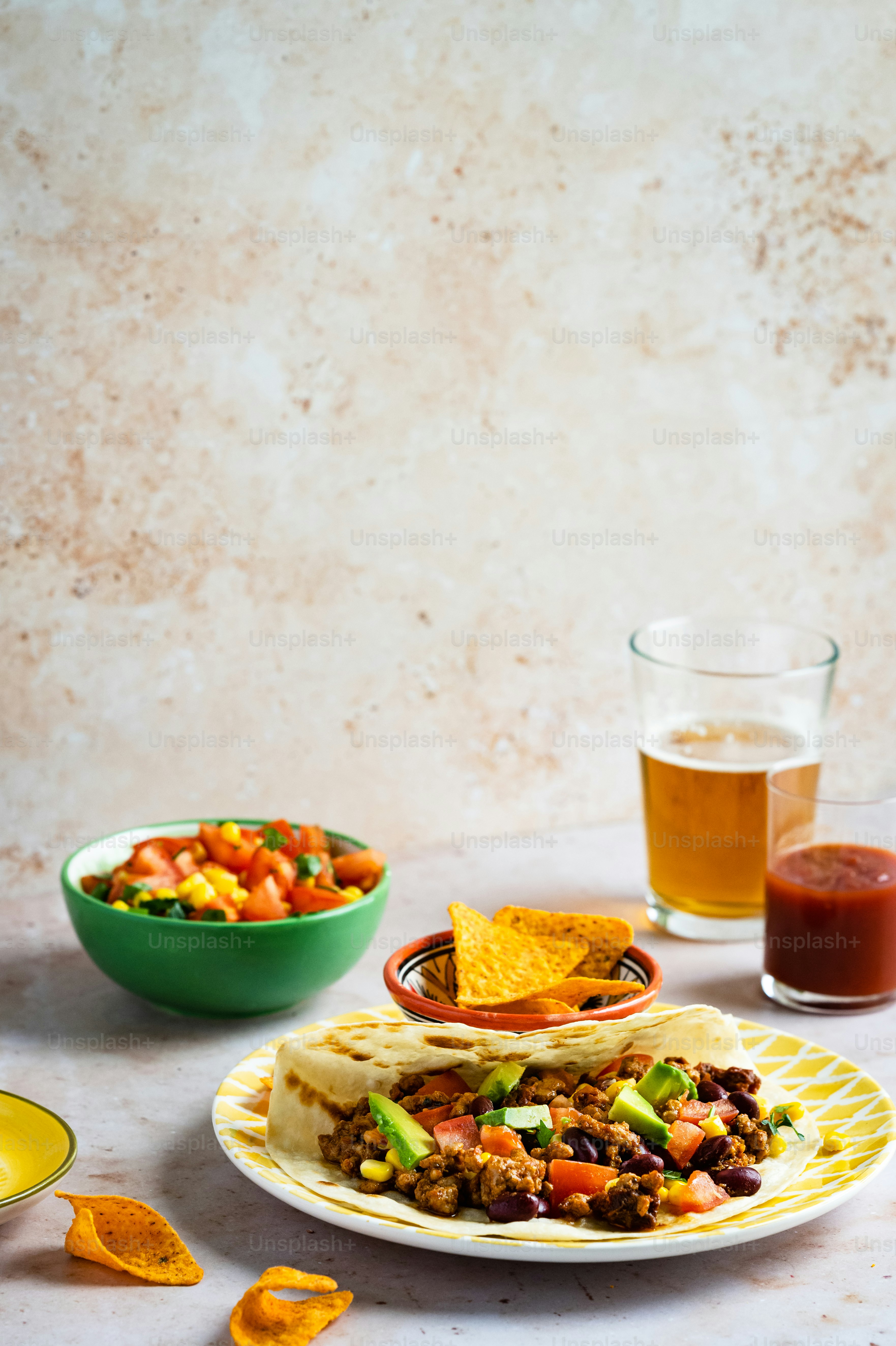 a plate of food and a glass of beer on a table