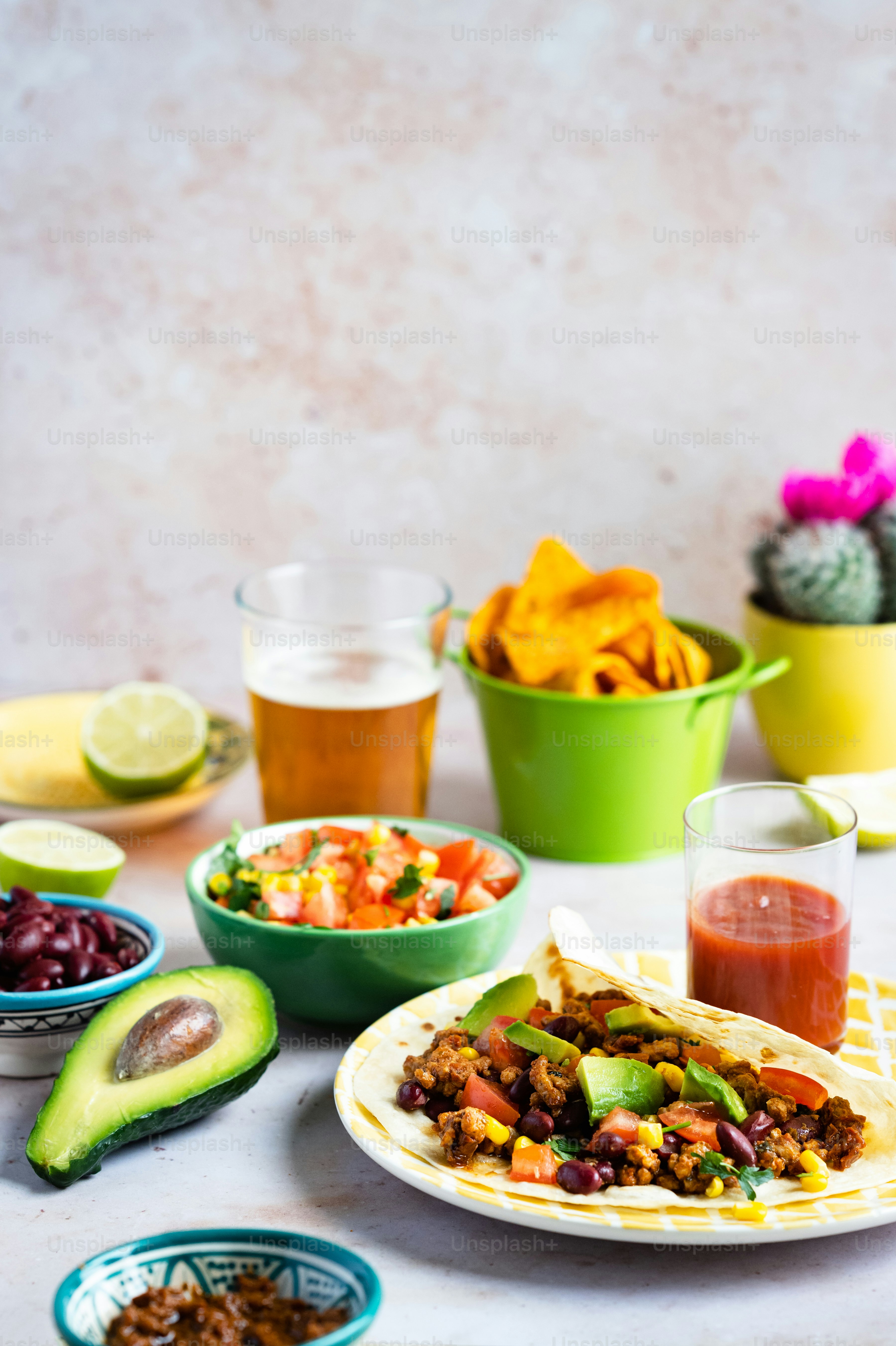 a table topped with plates of food and bowls of fruit