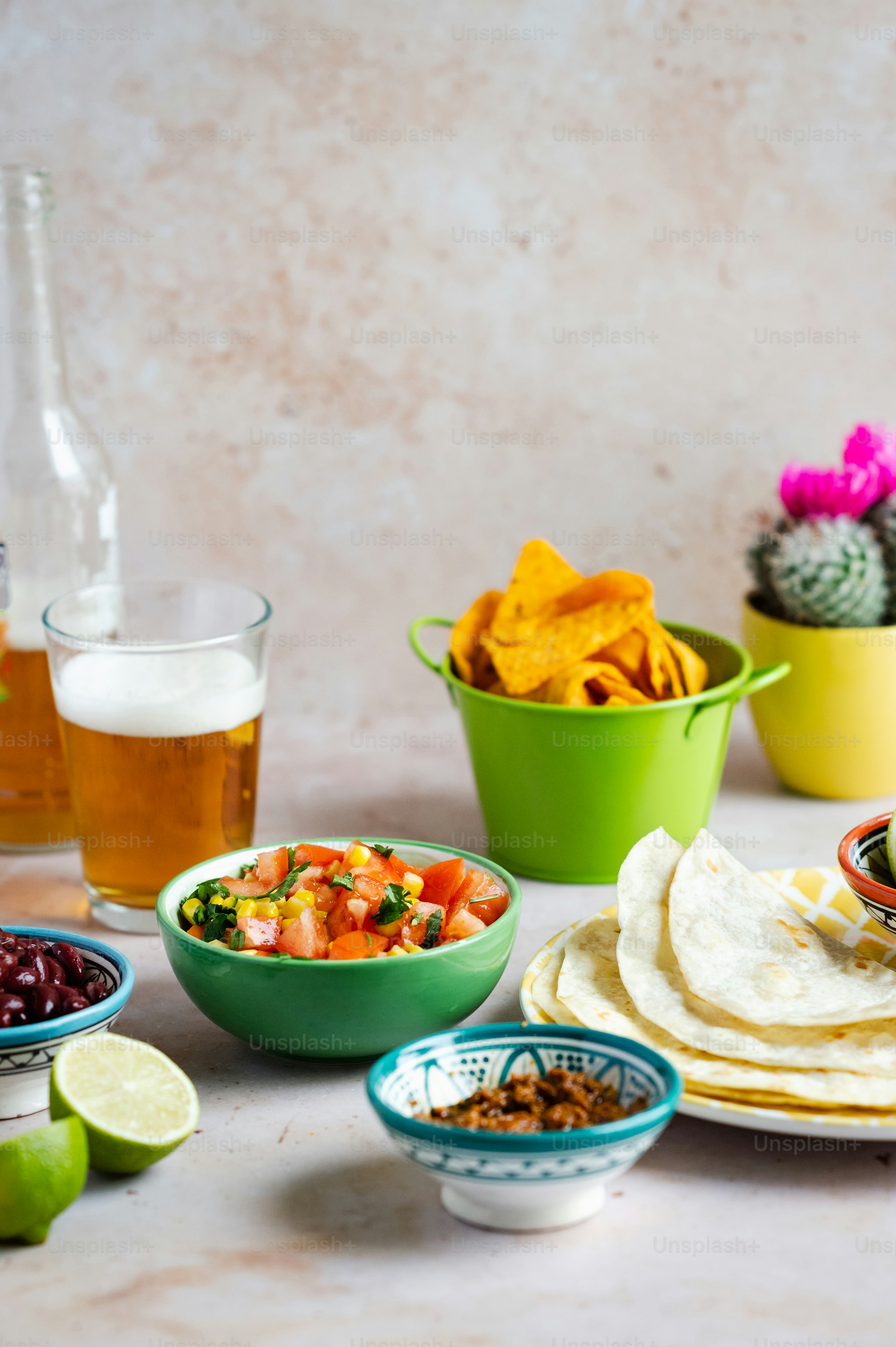 a table topped with bowls of food and drinks